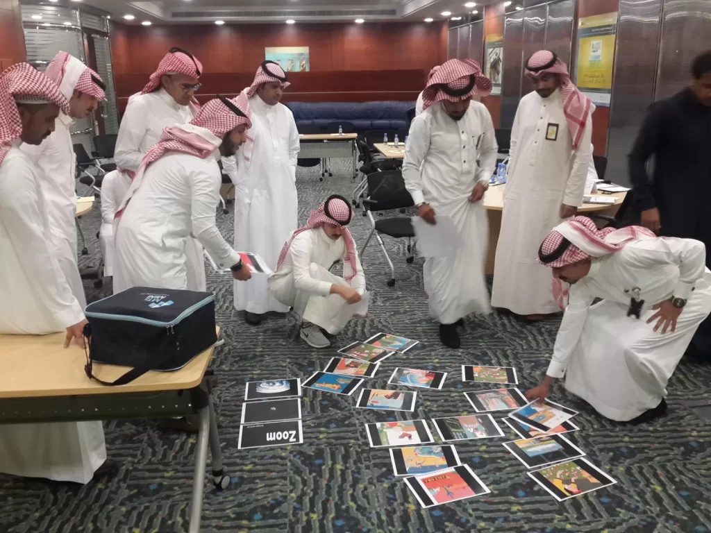 Participants arranging picture cards on the floor in a team activity