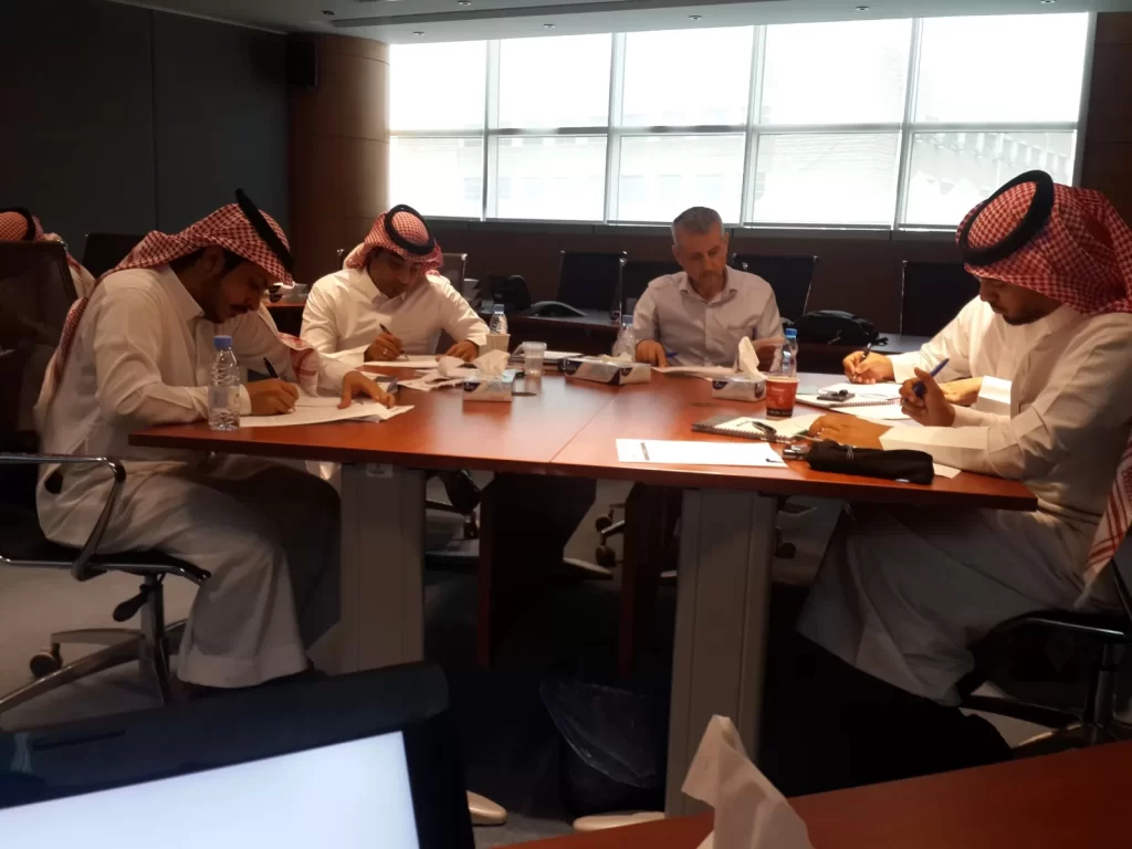 Participants working at a boardroom table during a workshop