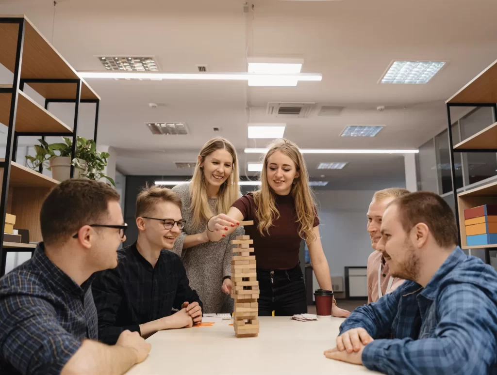 Colleagues playing a team-building tower game